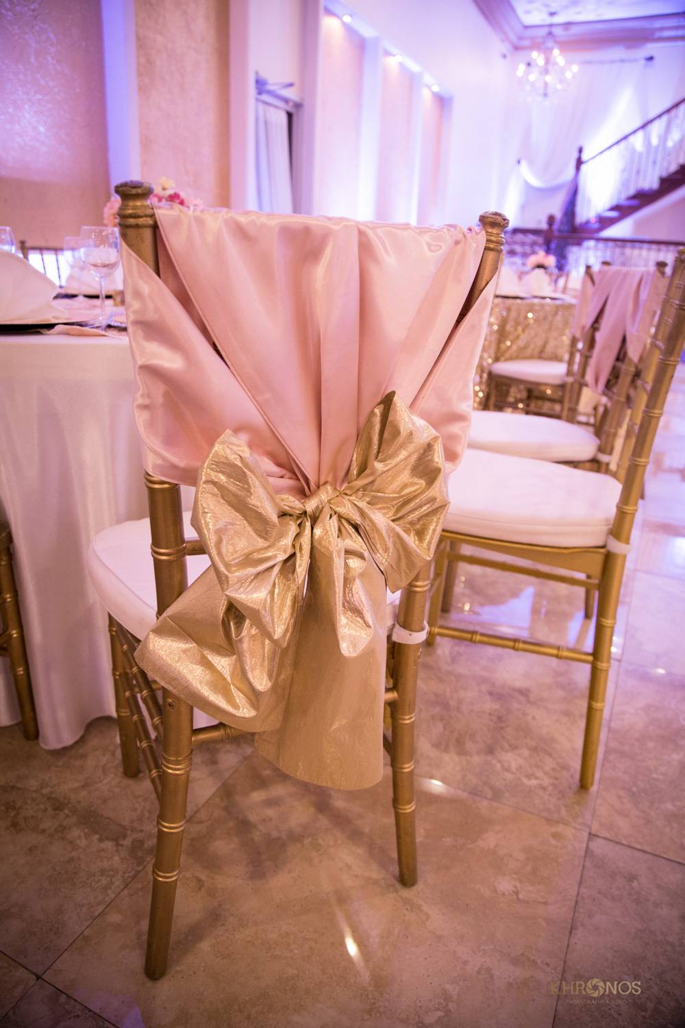 gold chair with pink cloth and gold ribbon decoration - Houston Private Events - Alegria Gardens gold chair with pink cloth and gold ribbon decoration - Houston Private Events - Alegria Gardens