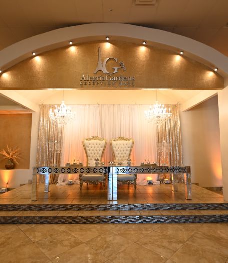 Cozy and elegant reception space at Alegria Gardens Houston event hall featuring warm lighting and a wedding cake.